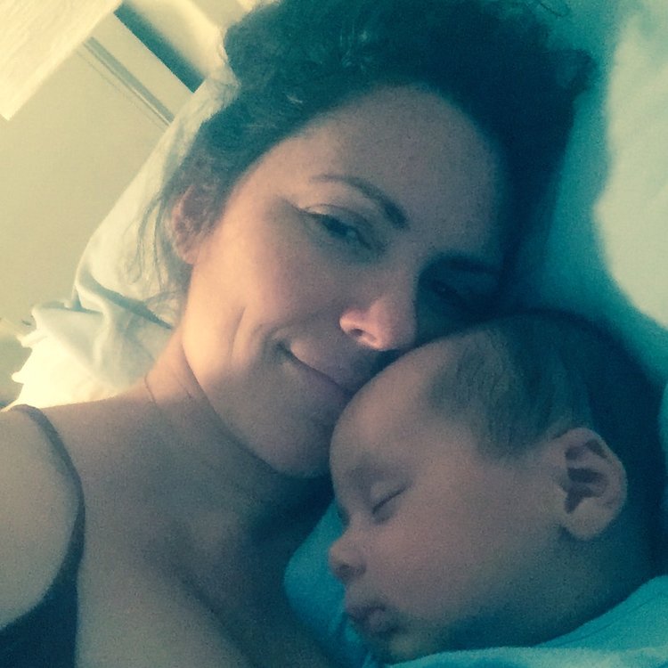 Selfie of mother laying with sleeping baby